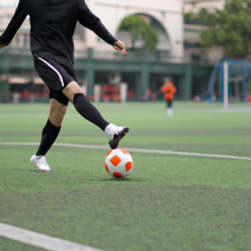 Cầu thủ bóng đá điều khiển bóng trên sân tập ở Hà Nội